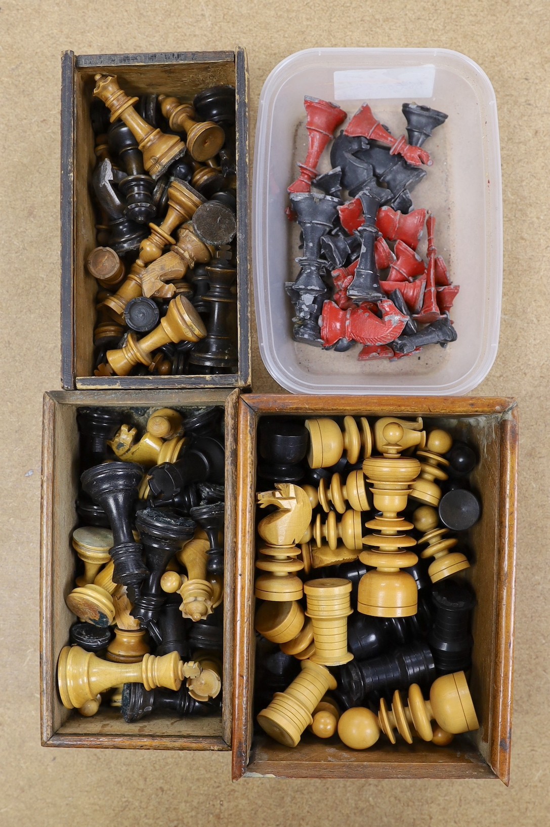 A painted lead chess set together with three boxed turned wooded chess sets.